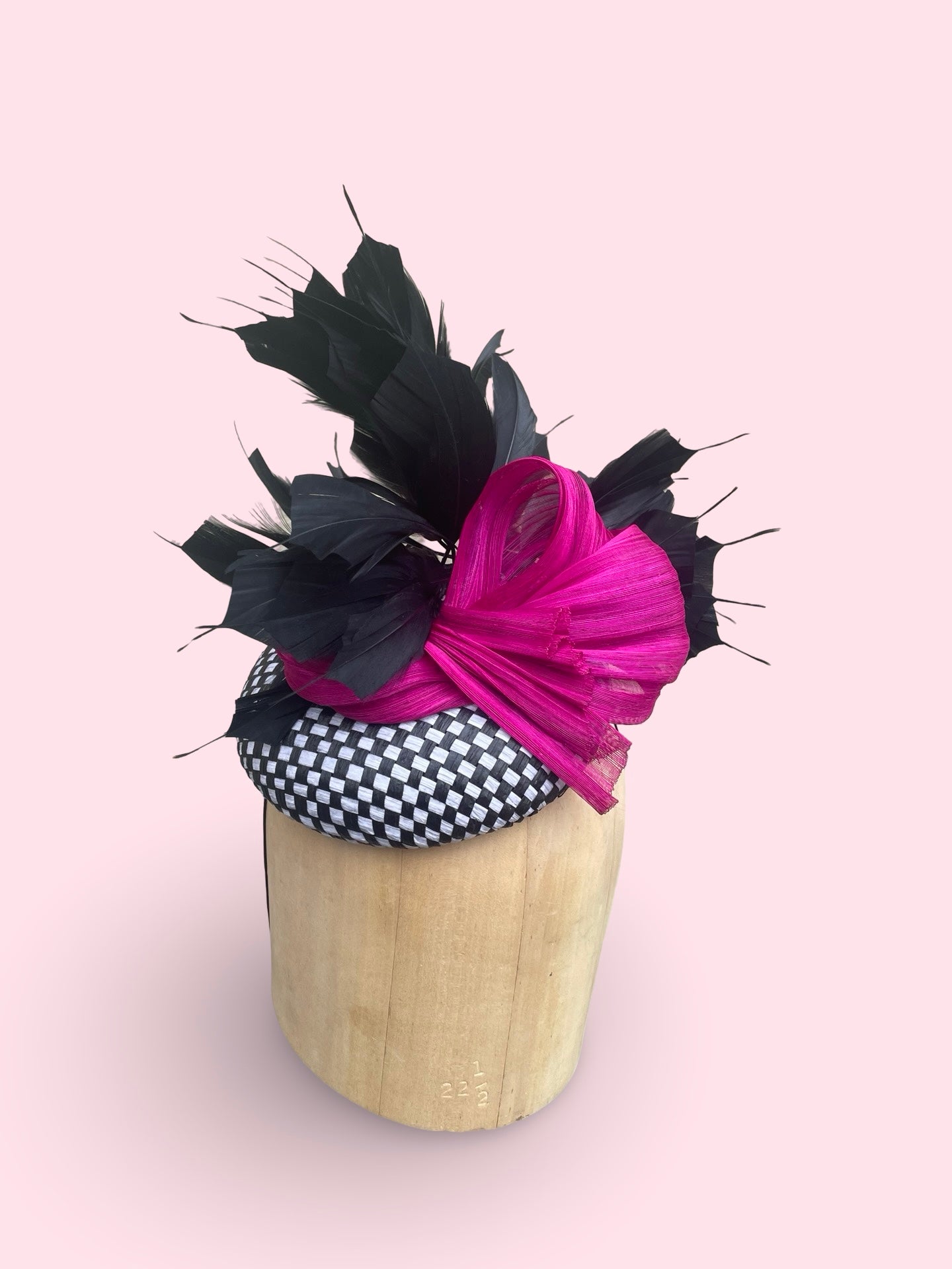 Black and white check straw pillbox with black feather spray and fuschia silk Abaca bow