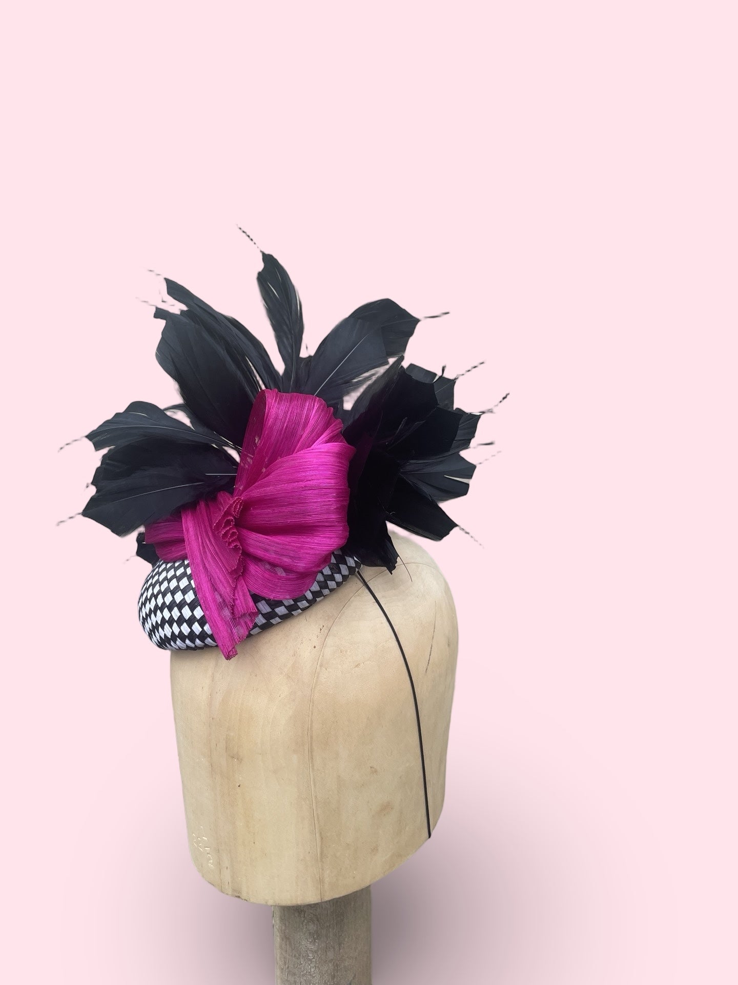 Black and white check straw pillbox with black feather spray and fuschia silk Abaca bow