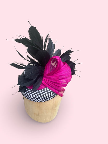 Black and white check straw pillbox with black feather spray and fuschia silk Abaca bow