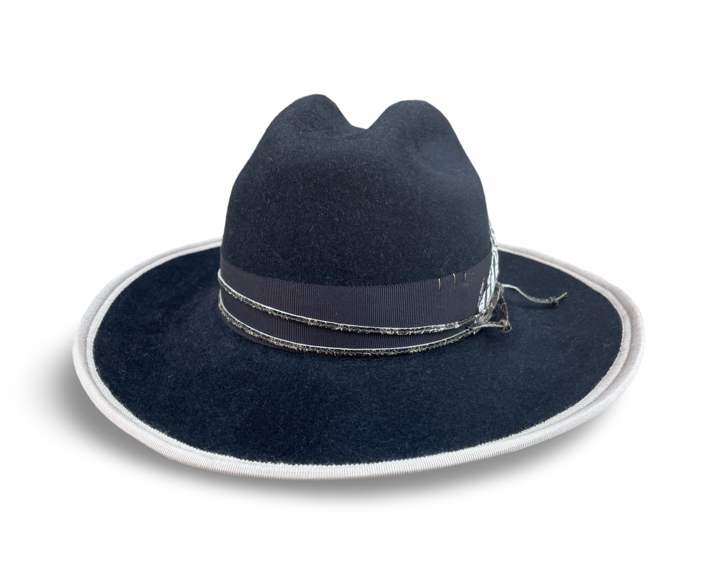 Black Fur Felt Cowboy hat, Open Road Crown with Grosgrain trim. Finished with distressed cord and feather. Brim is piped with Ivory Grosgrain. 