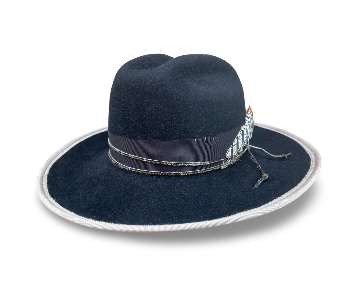 Black Fur Felt Cowboy hat, Open Road Crown with Grosgrain trim. Finished with distressed cord and feather. Brim is piped with Ivory Grosgrain. 