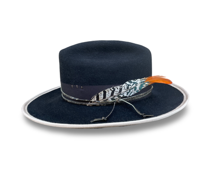 Black Fur Felt Cowboy hat, Open Road Crown with Grosgrain trim. Finished with distressed cord and feather. Brim is piped with Ivory Grosgrain. 