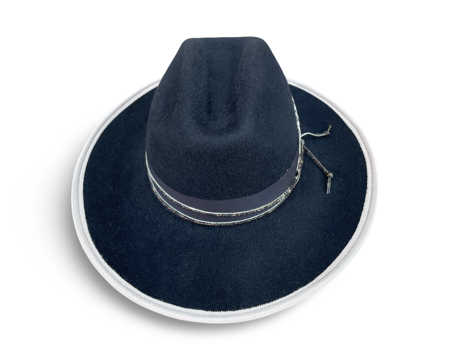 Black Fur Felt Cowboy hat, Open Road Crown with Grosgrain trim. Finished with distressed cord and feather. Brim is piped with Ivory Grosgrain. 