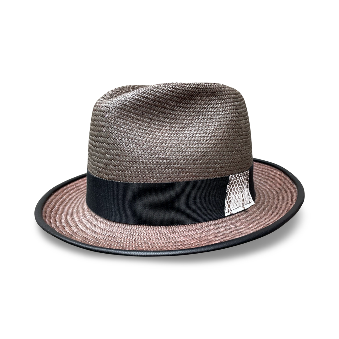 Side view of a Panama straw fedora with black leather piping on brim and black grosgrain ribbon trim. Trim features a snake skin detail on the left side. 
