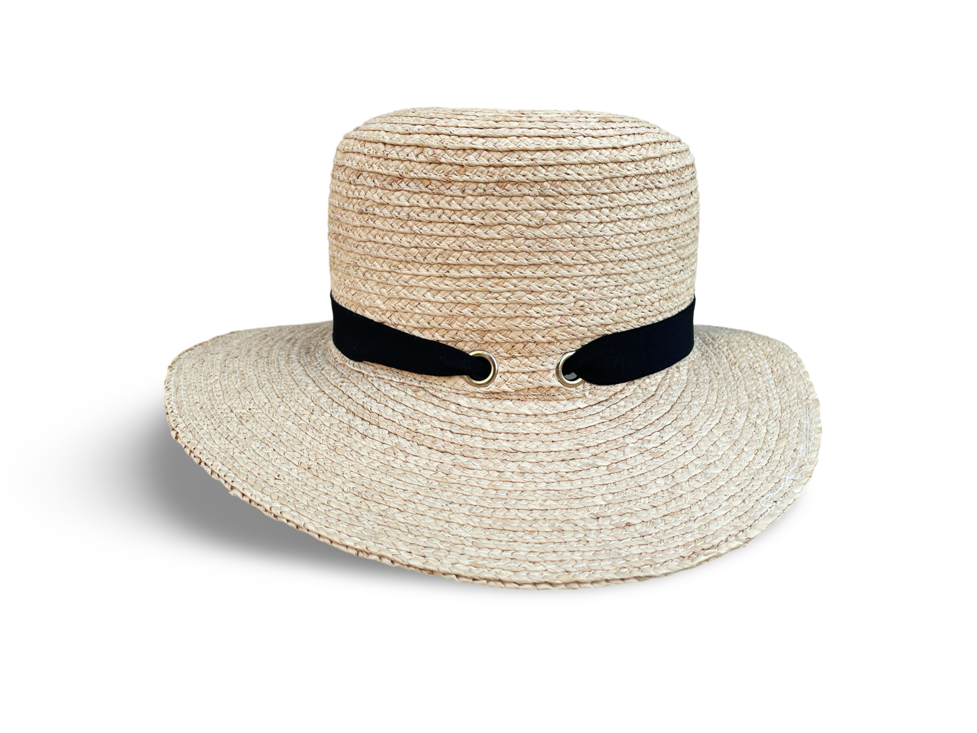 Left side view of Raffia packable, travel hat showing black trim laced through two gold grommets.