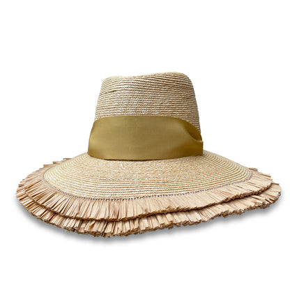Straw beach hat with double row of fringe on the brim. Crown has two gold grommets on the sides with a matching wide ribbon threaded through the grommets