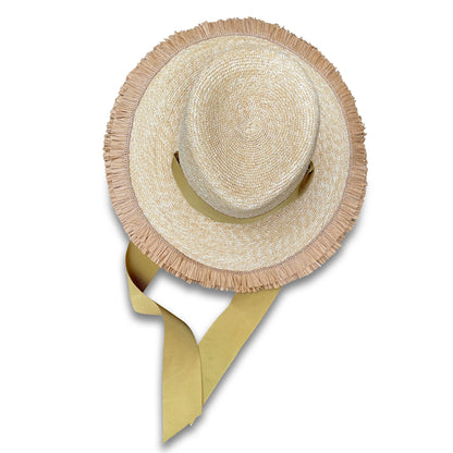 Wheat Straw Beach hat. View from the top. Brim features a double row of Raffia fringe. The hat has two grommets on each side of the crown with a matching ribbon threaded through. The ribbon acts as a chin ribbon.  